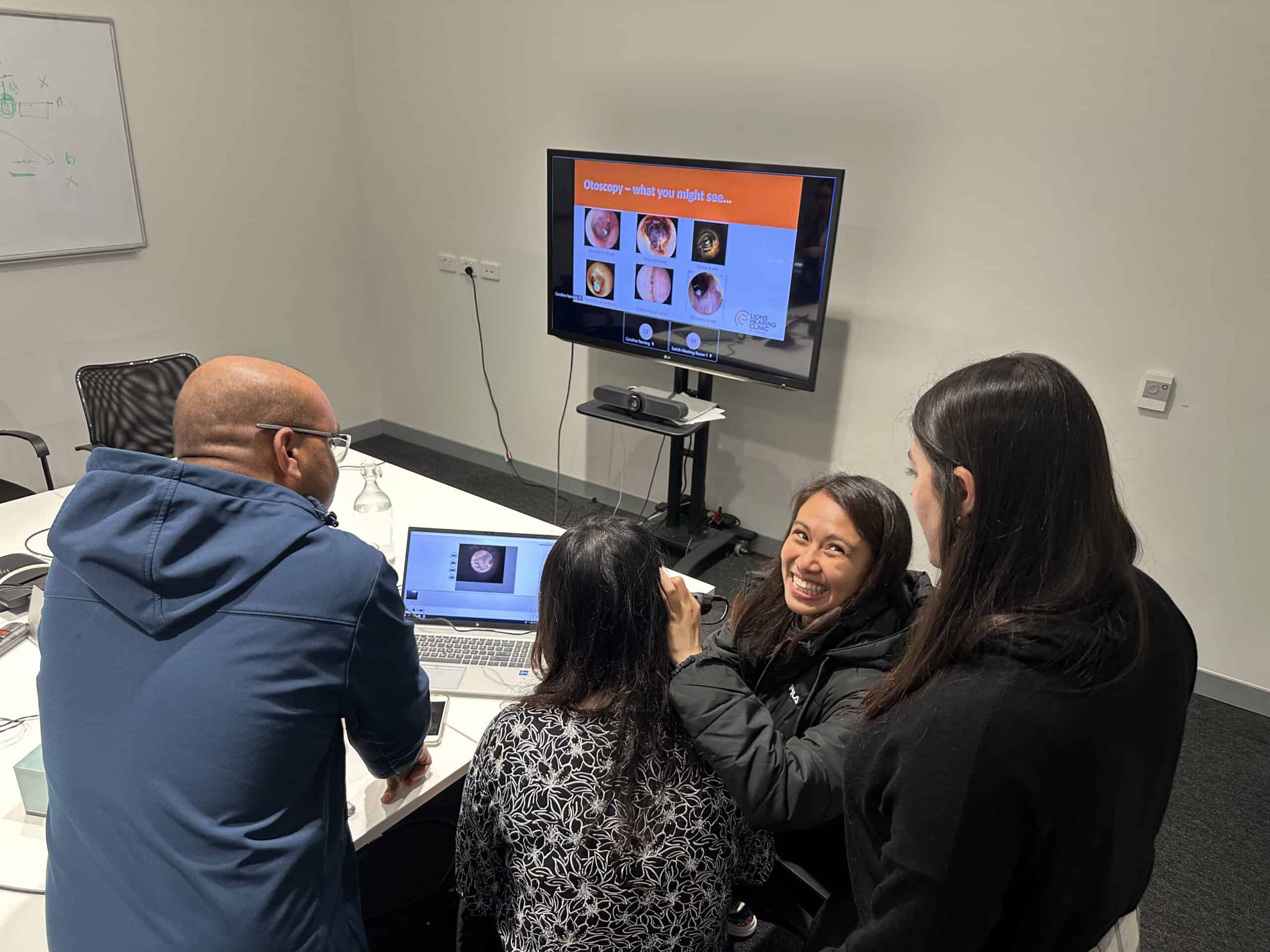 Researchers taking part in the otoscopy training session to understand how ear and hearing disorders are diagnosed and monitored.