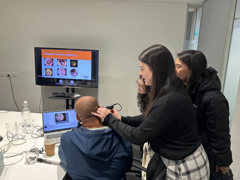 Caroline Fanning using an otoscope on a volunteer during the otoscope training session at Lions Hearing Clinic Nedlands.